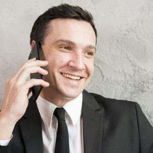 smiling-stylish-businessman-speaking-phone